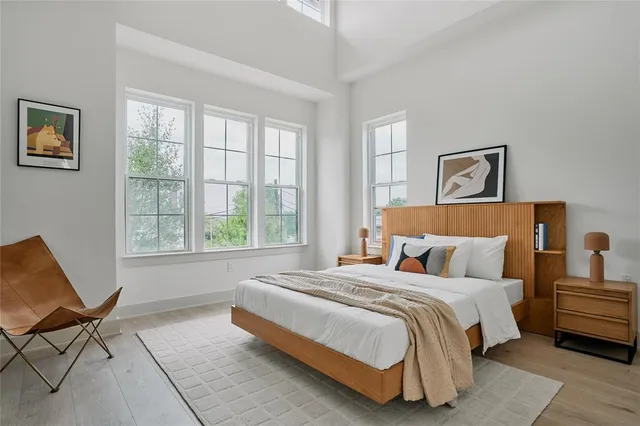 a bedroom with a bed and glass window