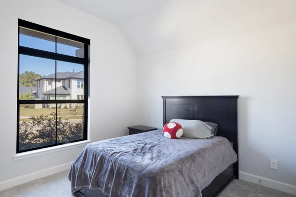 a bedroom with a bed and a window