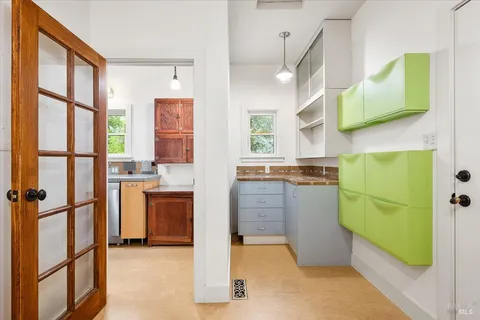 a kitchen with window and cabinets