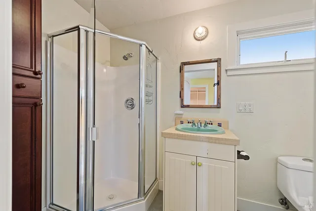 a bathroom with a sink toilet and shower