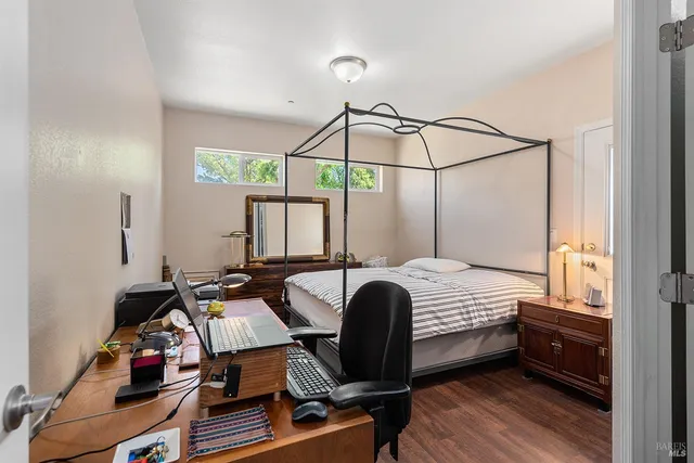 a bedroom with a bed and a desk