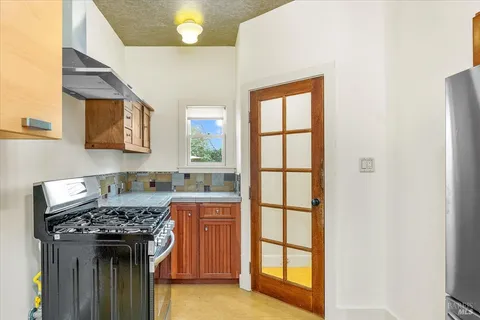 a kitchen with a stove a sink and a refrigerator