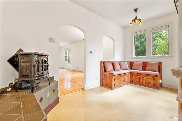 a living room with furniture a window and gym equipment