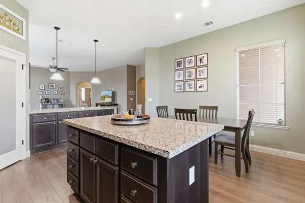 a kitchen with granite countertop wooden cabinets and stainless steel appliances