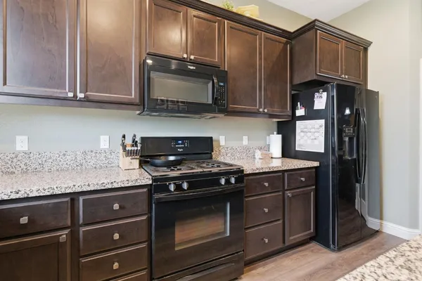 a kitchen with a stove and a refrigerator