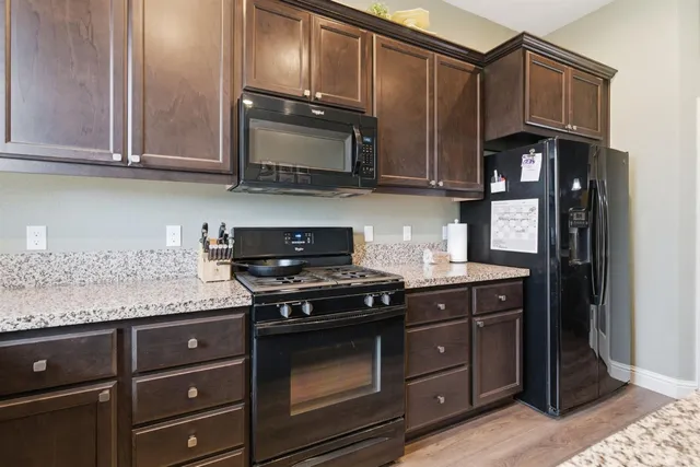 a kitchen with a stove and a refrigerator