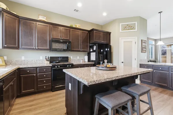 a kitchen with stainless steel appliances granite countertop a sink stove and microwave