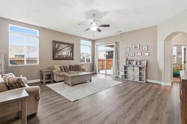 a living room with furniture and wooden floor
