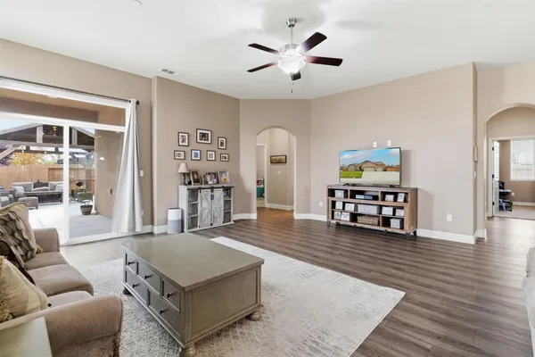 a living room with furniture and a wooden floor