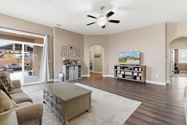 a living room with furniture and a wooden floor
