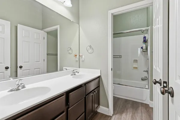 a bedroom with a bed a table and chair