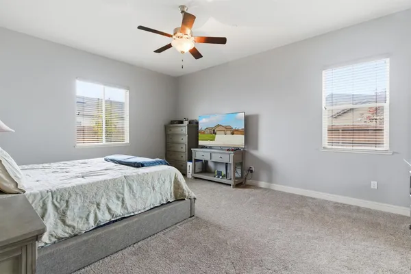 a spacious bedroom with a bed and a cabinets