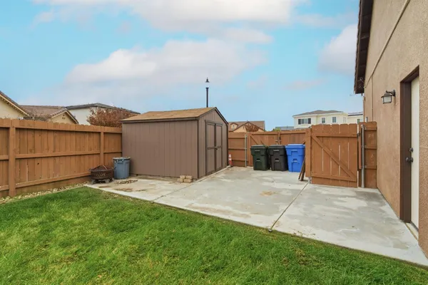 a view of a house with a yard and garage