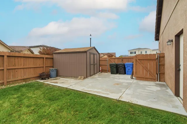 a view of a house with a yard and garage