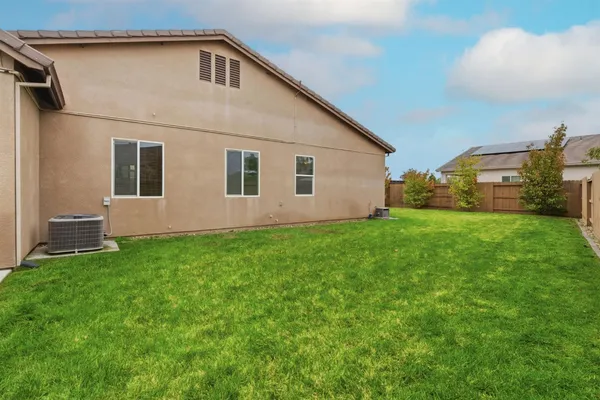 a view of house with yard