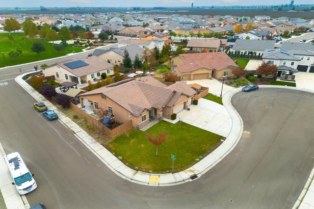 an aerial view of residential houses with outdoor space