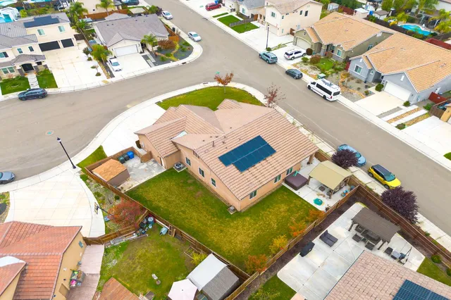 an aerial view of a house with a swimming pool