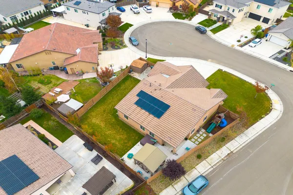 an aerial view of a house with yard swimming pool and outdoor seating