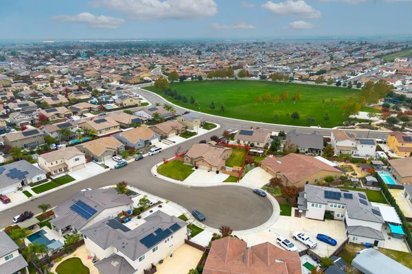 an aerial view of residential houses with yard