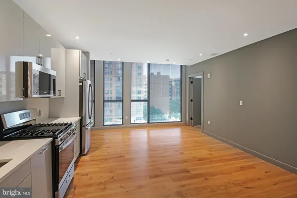 a large kitchen with cabinets and stainless steel appliances
