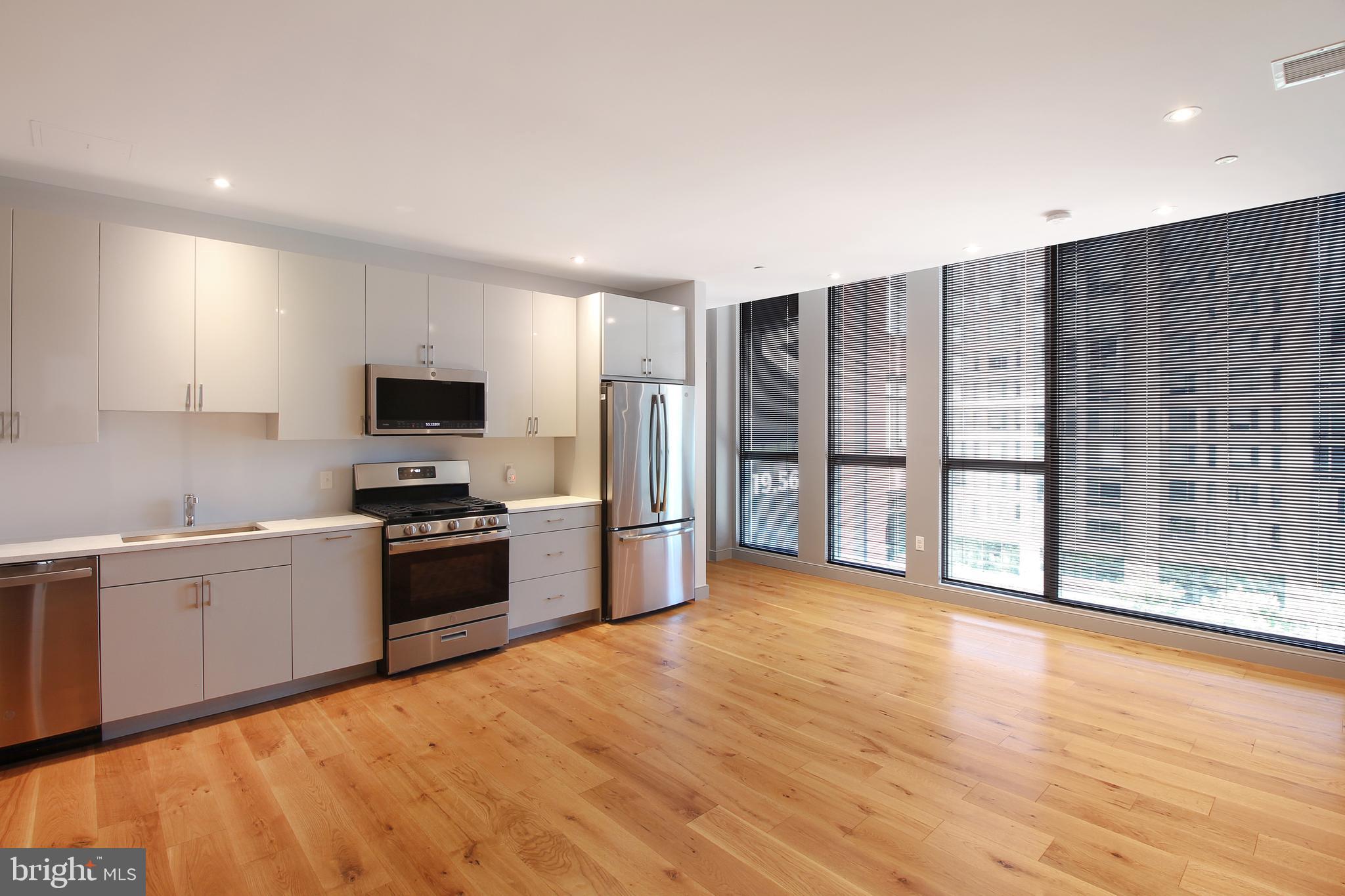 448 K Street Northwest, Unit 601 Washington, DC 20001 - Photo 9 of 29 a large kitchen with cabinets and stainless steel appliances