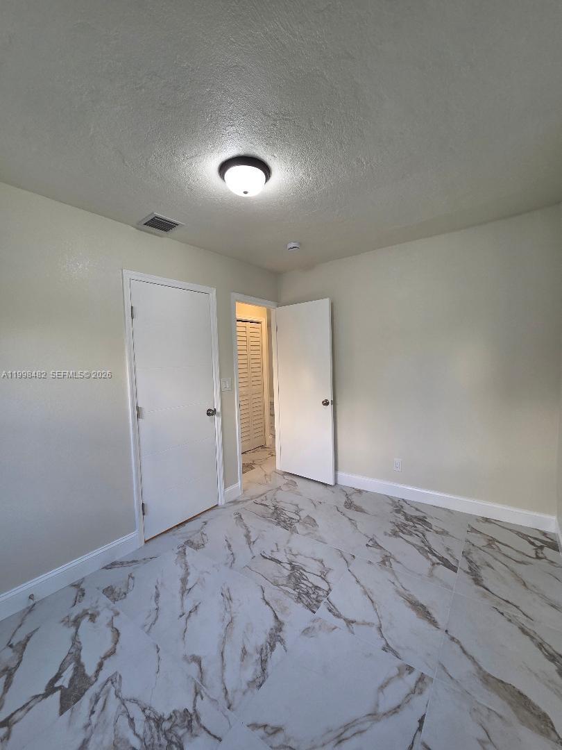 295 Northwest 48th Street Miami, FL 33127 - Photo 11 of 12 an empty room with a natural light