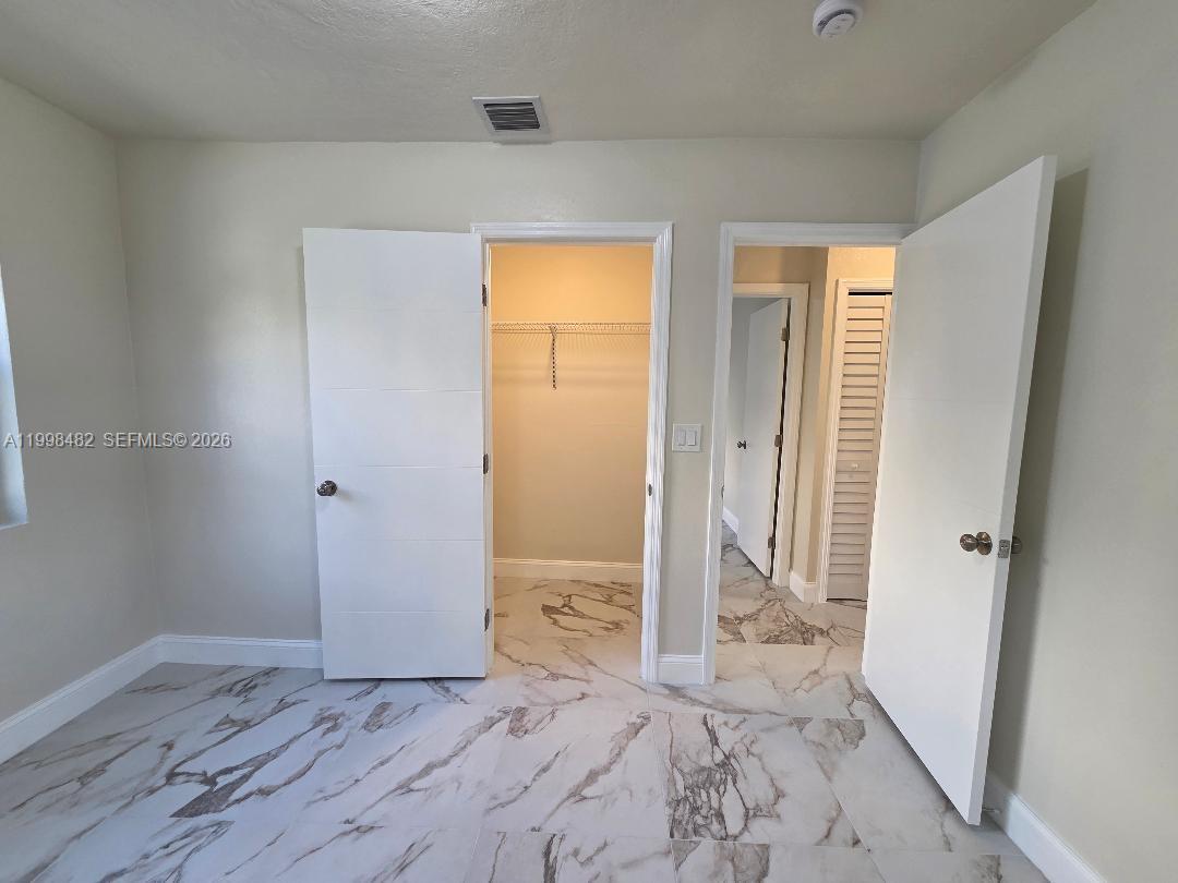 295 Northwest 48th Street Miami, FL 33127 - Photo 12 of 12 wooden floor in a room with a bathroom