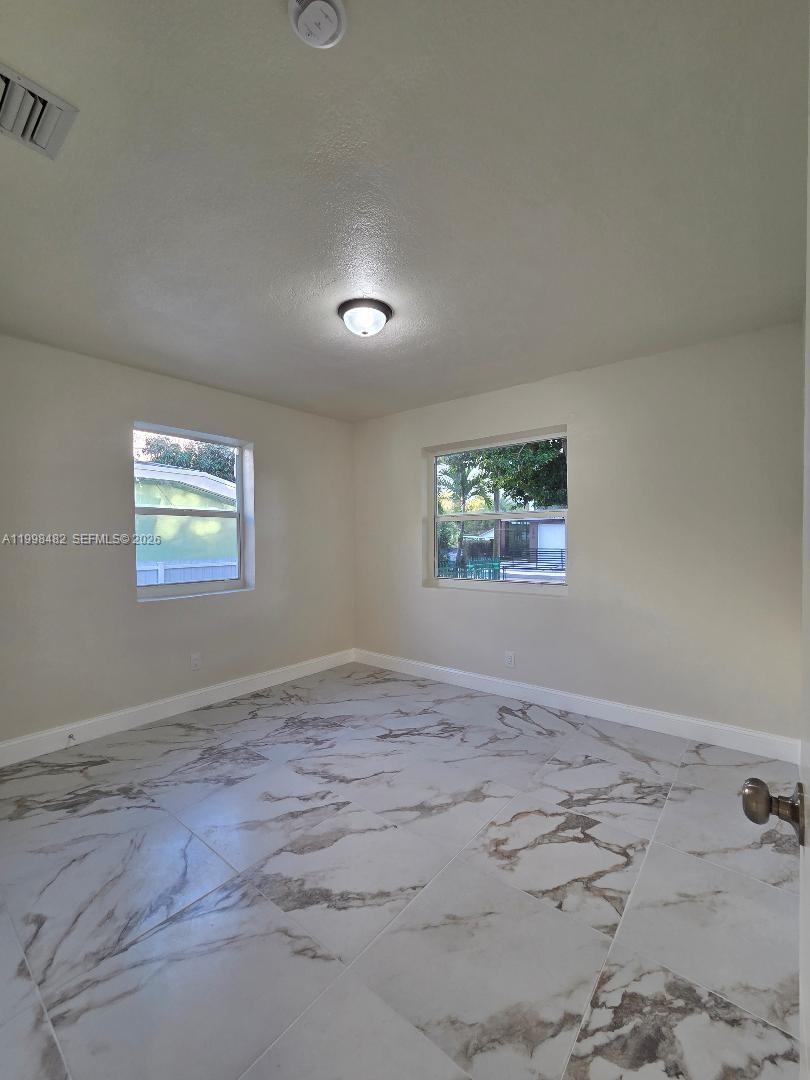 295 Northwest 48th Street Miami, FL 33127 - Photo 10 of 12 an empty room with windows
