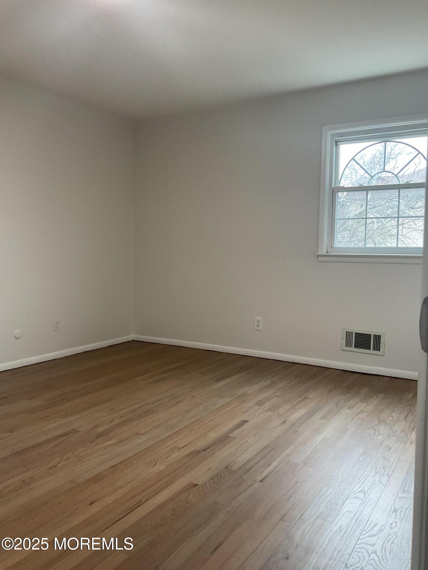 117 Greymoor Road Howell, NJ 07731 - Photo 24 of 41 an empty room with wooden floor and windows