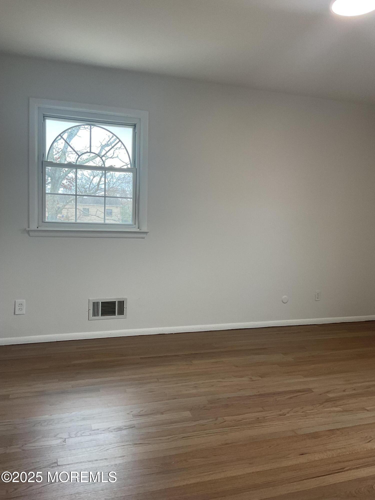 117 Greymoor Road Howell, NJ 07731 - Photo 25 of 41 a view of an empty room with wooden floor and a window
