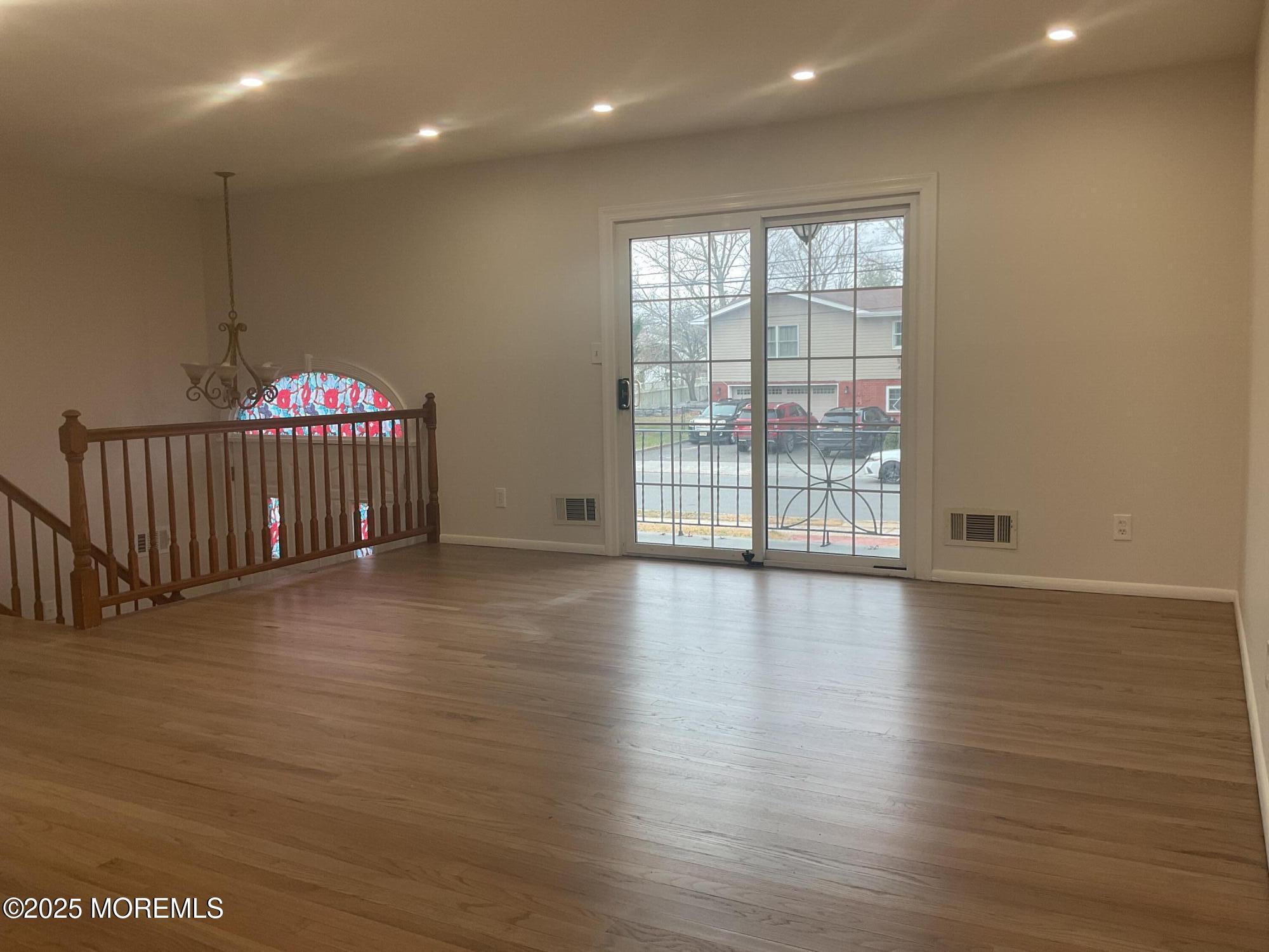 117 Greymoor Road Howell, NJ 07731 - Photo 5 of 41 a view of an empty room with wooden floor and a window