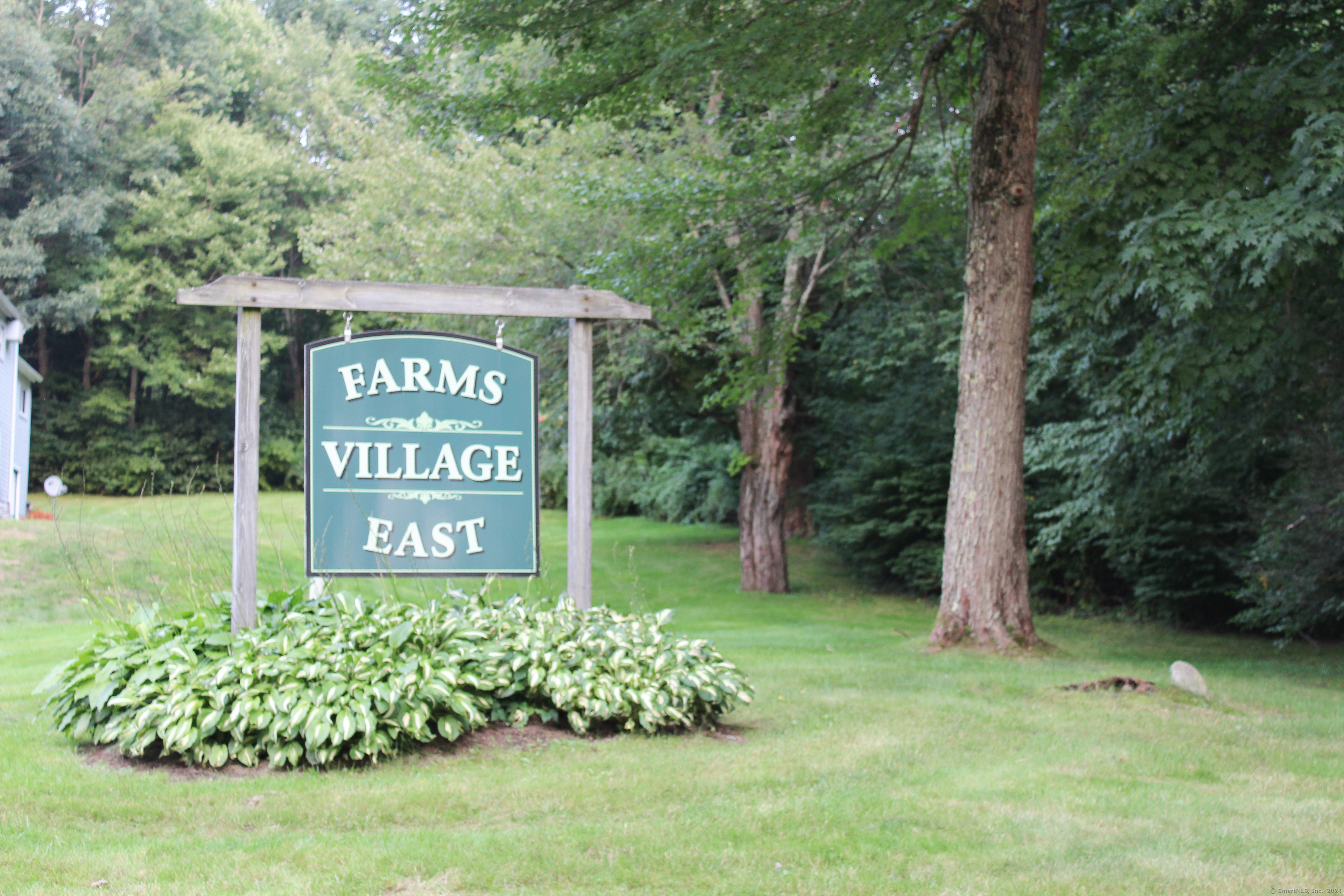 7 East Farms Road, Unit B Torrington, CT 06790 - Photo 1 of 1 a sign that is sitting in the grass