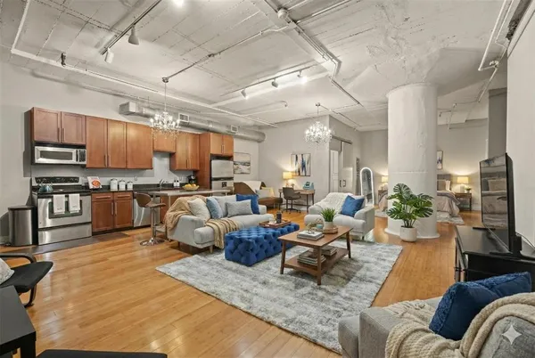 a living room with furniture kitchen view and a kitchen view