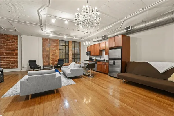 a living room with furniture and a chandelier