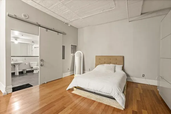 a bedroom with a bed and a table