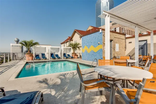 a view of a house with swimming pool and sitting area