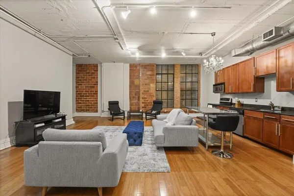 a living room with fireplace furniture and a flat screen tv