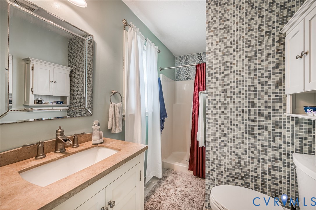 6327 Draperfield Road Mechanicsville, VA 23111 - Photo 19 of 23 Bathroom featuring vanity, a stall shower, light t