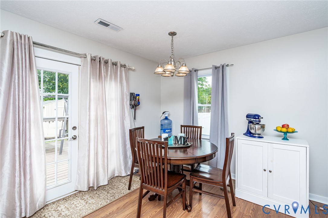 6327 Draperfield Road Mechanicsville, VA 23111 - Photo 9 of 23 Dining area with wood finished floors and a chande
