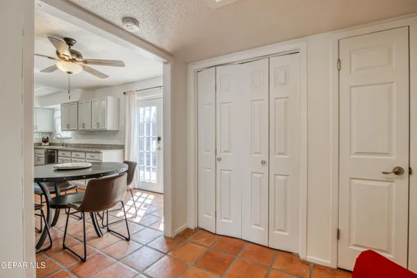 a view of a kitchen with kitchen island and stainless steel appliances