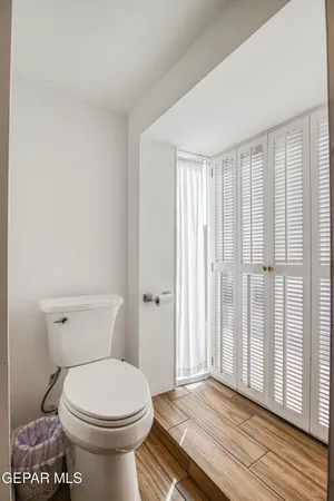 a bathroom with a toilet and a window