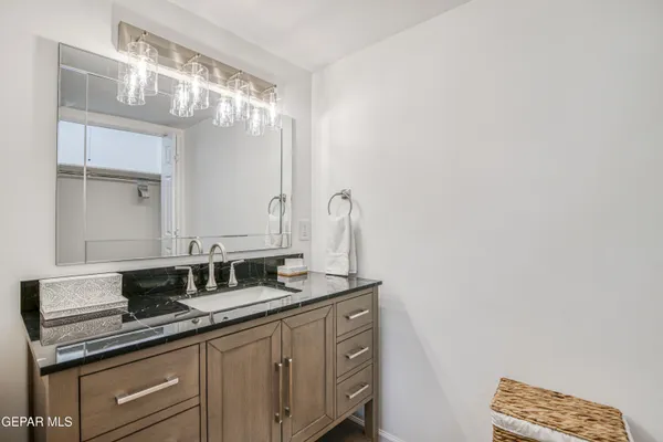 a bathroom with a double vanity sink and a mirror