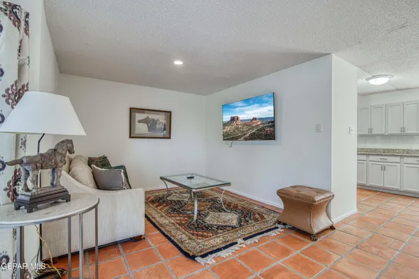 a living room with furniture and a lamp