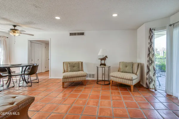 a living room with furniture a rug and a window