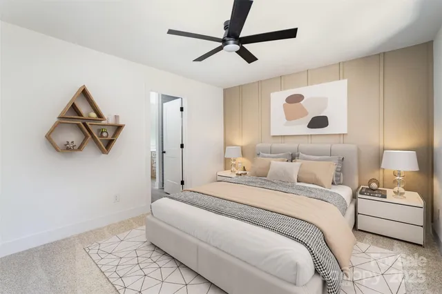 a bedroom with a bed and a painting on the wall