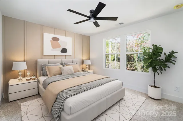 a bedroom with a large bed and a potted plant