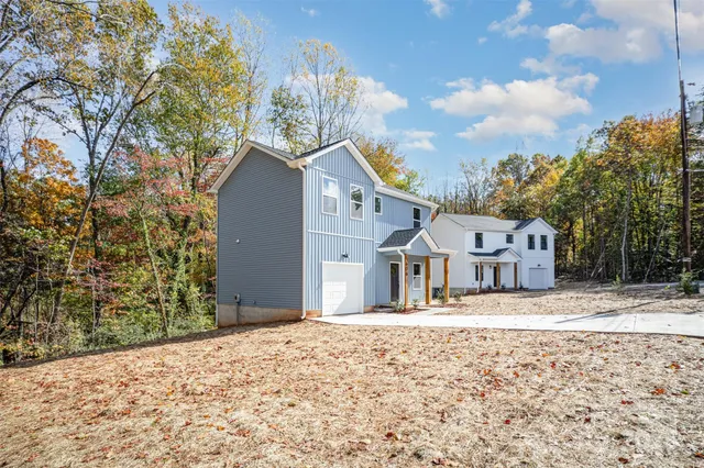 a porch with a bench and trees