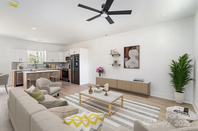 a living room with furniture and kitchen view
