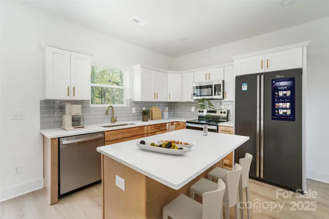 a kitchen with a refrigerator a stove a sink and a refrigerator