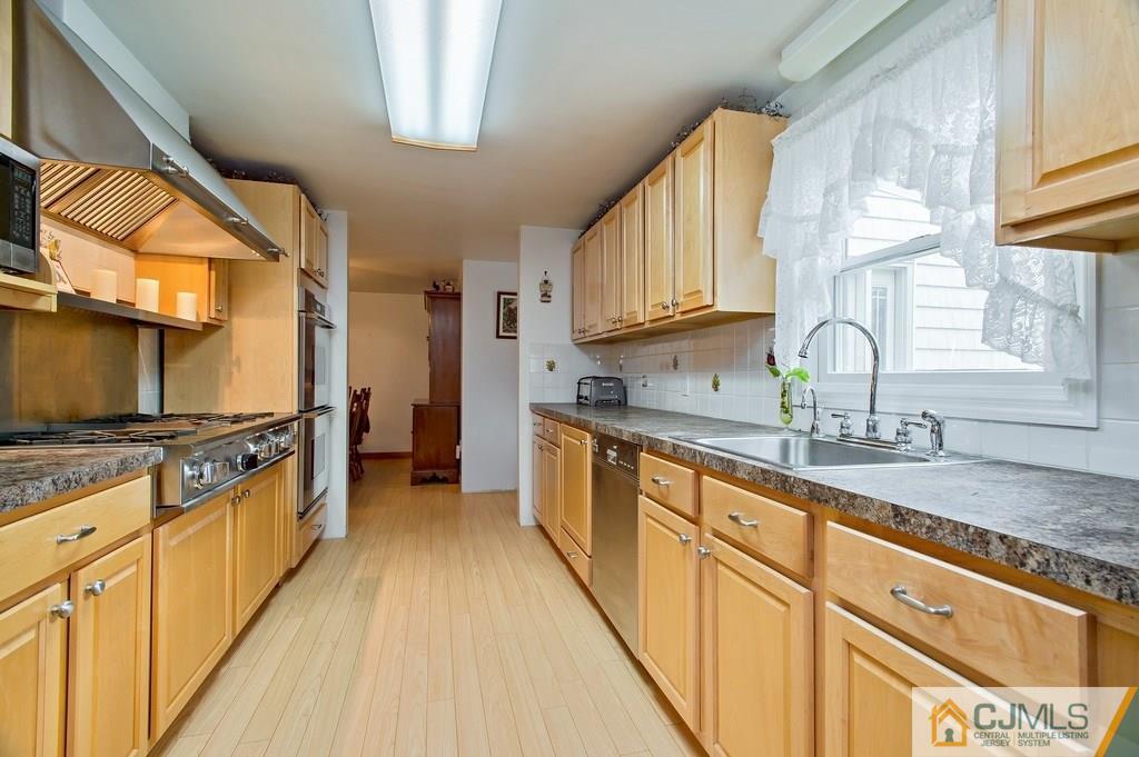 1670 Washington Valley Road Bridgewater, NJ 08836 - Photo 2 of 18 a kitchen with stainless steel appliances granite countertop a stove a sink and a granite counter tops